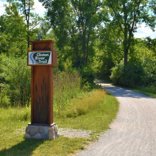 A beautiful community at the heart of all your passions a sign next to a path